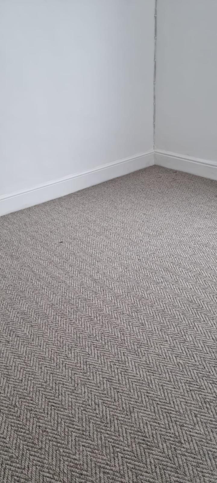 Herringbone-weave natural loop carpet in a bedroom