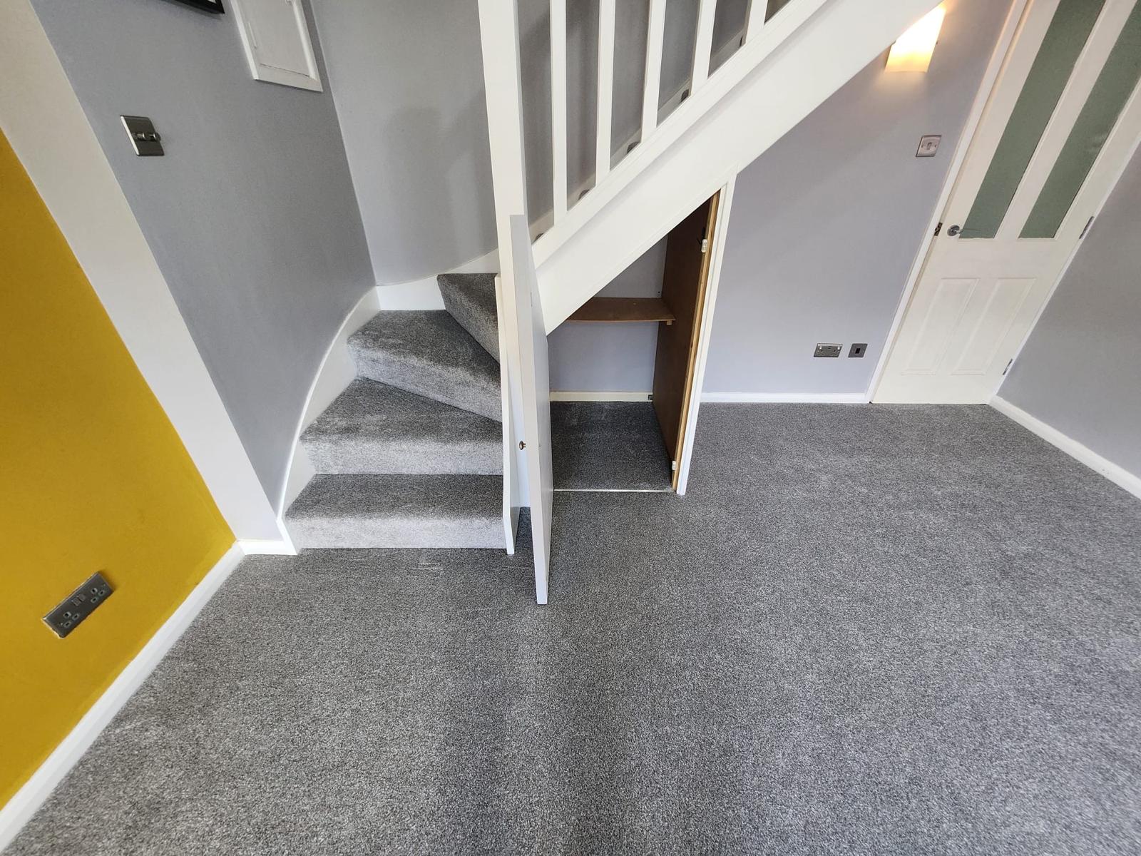 Grey twist pile carpet fitted through hallway and stairs